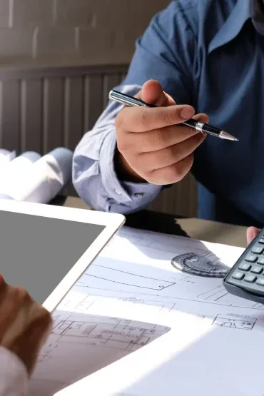 Établissement d’un devis de déménagement sur un plan, calculatrice à la main